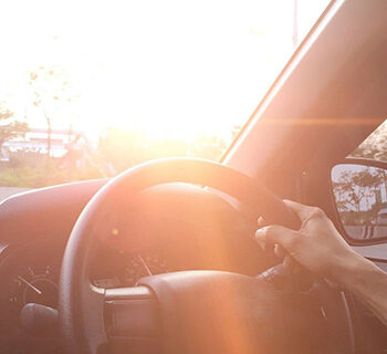 View of a Man with his hand of the car steering