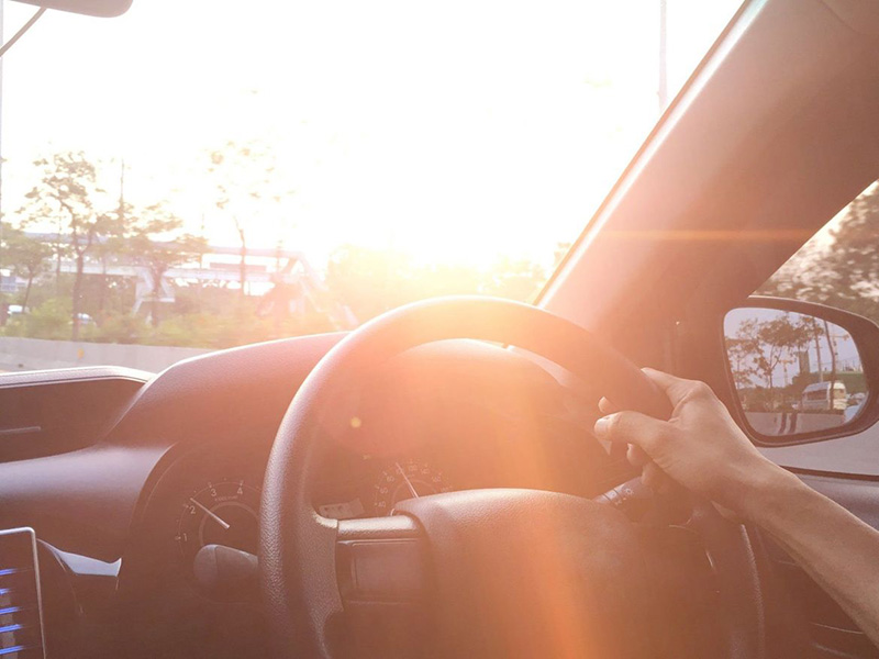 View of a Man with his hand of the car steering